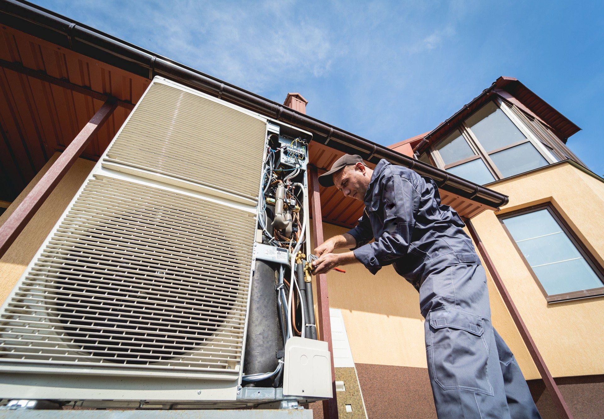 HVAC technician servicing home heating and cooling system